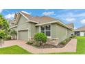 Beautiful townhouse with brick pathway, stone accents, and well-kept lawn at 6528 Sedgeford Dr, Lakeland, FL 33811