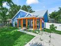 Attractive blue home with a covered porch supported by wooden beams, enhancing curb appeal at 7714 Chase Rd, Lakeland, FL 33810