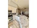 Open concept kitchen with a large granite island, stainless steel appliances, and modern cabinetry at 7929 Ashley Pointe Dr, Lakeland, FL 33810