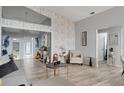 Cozy living room features wood-look tile flooring and neutral tones at 7929 Ashley Pointe Dr, Lakeland, FL 33810