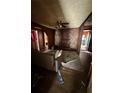 Living room featuring wood paneling, a fireplace, ceiling fan, and hardwood floors at 803 26Th Nw St, Winter Haven, FL 33881