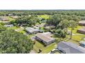 Wide aerial perspective showcases the home’s position with a fenced yard, greenery, and neighborhood setting at 1019 Milner E Dr, Lakeland, FL 33810