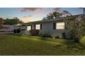 Well-maintained single-story home showcasing lush green lawn, brick facade and manicured landscaping at 1019 Milner E Dr, Lakeland, FL 33810
