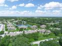 Expansive aerial view of the community with a tranquil lake and lush trees at 1102 Eagle Pond Dr # 1102, Winter Haven, FL 33884