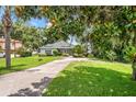 Quaint single-story home on a large lot featuring a spacious front yard and mature landscaping at 15 Edwards Shrs, Haines City, FL 33844