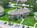 This is an aerial view of the condo building and surrounding landscaping with the parking lot below at 1507 Eagle Pond Dr # 1507, Winter Haven, FL 33884