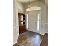 Inviting foyer with wood-look flooring, a rustic cabinet, and a decorative rug at 1790 Turtle Rock Dr, Lakeland, FL 33803