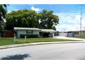 Street view of charming single story home with a well-maintained lawn and covered parking at 2021 Oliver Pl, Winter Haven, FL 33881