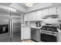 Updated kitchen with stainless steel appliances, white cabinetry, and a gas range for modern cooking at 2037 San Marcos Se Dr # 443, Winter Haven, FL 33880