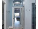 Hallway view to bedroom with balcony in neutral tones at 209 Andros Ave # 15301, Davenport, FL 33897