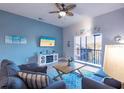 Cozy living room with ceiling fan and blue accents at 209 Andros Ave # 15301, Davenport, FL 33897