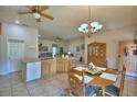 Open kitchen and dining area with a chandelier, tile flooring, and wood cabinets at 2252 Fox Run Rd, Lake Wales, FL 33898