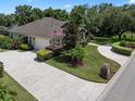 Stunning aerial view showcases the home's lush landscaping and brick-paved driveway at 2977 Sequoyah Dr, Haines City, FL 33844