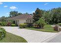 Charming home boasts lush landscaping, brick-paved driveway, and attached garage at 2977 Sequoyah Dr, Haines City, FL 33844