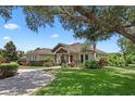 Attractive single-story home features mature trees, stone accents and brick paved driveway at 2977 Sequoyah Dr, Haines City, FL 33844