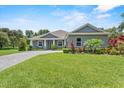 Inviting single-story home with well-maintained lawn and landscaping, showcasing the home's curb appeal at 2988 Sequoyah Dr, Haines City, FL 33844