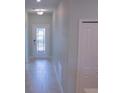 Bright hallway with tile flooring and a decorative glass front door at 3023 Caneel, Winter Haven, FL 33884