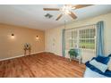 Spacious living room boasting hardwood floors, a front door, and a large window for ample natural light at 304 W Lake Ave, Auburndale, FL 33823