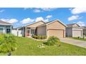 Charming single-Gathering home featuring a well-manicured lawn and an attached two-car garage at 3173 Whispering Trails Ave, Winter Haven, FL 33884