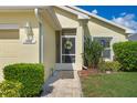 Inviting front door with charming wreath detail and manicured landscaping at 348 Lake Suzanne Dr, Lake Wales, FL 33859