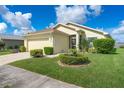Well-maintained home exterior with lush landscaping and a paver driveway at 348 Lake Suzanne Dr, Lake Wales, FL 33859