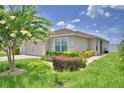Beautifully landscaped front yard with a mature tree complementing the cozy home at 373 St Georges Cir, Eagle Lake, FL 33839