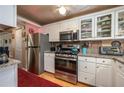 Well-lit kitchen with stainless steel appliances, granite countertops and ample cabinet space at 400 El Camino Dr # 201, Winter Haven, FL 33884