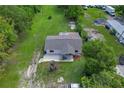 Aerial shot showcases home's placement on a spacious, well-maintained lot with mature trees at 407 Snively Ave, Winter Haven, FL 33880