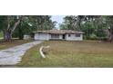 Exterior of single story home in Dunnellon, Florida features an attached single car garage and concrete driveway at 4160 Poinciana Dr, Indian Lake Estates, FL 33855