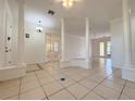 Open living area featuring tile floors, decorative columns, and plenty of natural light at 4469 Turnberry Ln, Lake Wales, FL 33859