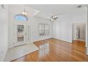 Bright living room featuring hardwood floors, a ceiling fan, and a sunlit entryway at 5340 Nicklaus Dr, Winter Haven, FL 33884