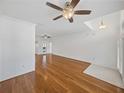 Spacious living area with hardwood floors, ceiling fans, and a view into adjacent rooms at 5340 Nicklaus Dr, Winter Haven, FL 33884