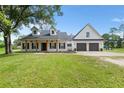 Lovely two-story home featuring a well-manicured lawn, front porch, and an attached two-car garage at 5820 E Johnson Ave, Haines City, FL 33844