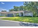 Beautiful single-story home featuring a landscaped front yard and covered front porch entrance at 6028 Hillside Heights Dr, Lakeland, FL 33812