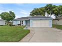 Charming single-story home with a well-manicured lawn and a two-car garage in a peaceful neighborhood at 6192 Magpie Dr, Lakeland, FL 33809