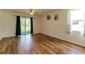 Open concept living space with ceiling fan and sliding glass doors at 6300 Dolostone Dr, Lakeland, FL 33811