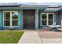 Close-up view of the front door, walkway, and front lawn at 704 Butternut Pl, Lakeland, FL 33813