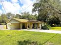 Lovely home featuring a covered carport and a spacious front yard, perfect for outdoor activities at 8110 Walt Williams Rd, Lakeland, FL 33809