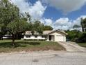 Charming single-Gathering home with a well-maintained lawn and attached one car garage at 816 Casselberry Dr, Lake Wales, FL 33853