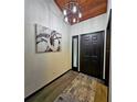 Modern entryway with wood-look floors, bold art, and contemporary light fixture at 816 Pinewood Ct # 3126, Haines City, FL 33844