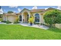 Lovely one-story home featuring arched windows and a manicured lawn at 10708 Belo Horizonte Ave, Clermont, FL 34711