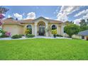 Charming single-story home featuring mature landscaping and impeccable curb appeal at 10708 Belo Horizonte Ave, Clermont, FL 34711