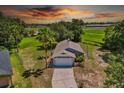 An aerial view shows the grey single-story home on a large lot at 1100 Lowry Ave # 63, Lakeland, FL 33801