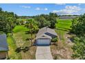 An aerial view shows the grey single-story home on a large lot at 1100 Lowry Ave # 63, Lakeland, FL 33801
