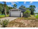Charming single-story home with a two-car garage and lush landscaping at 1100 Lowry Ave # 63, Lakeland, FL 33801