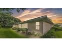 Home featuring well-maintained landscaping, exterior windows, and neutral paint at 13 Enclave Dr, Winter Haven, FL 33884