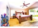 Cozy bedroom with vaulted ceiling, sliding glass door, and comfortable furnishings at 2169 Rose Blvd, Winter Haven, FL 33881