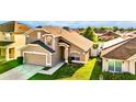 Charming two-story home featuring an attached garage and well-maintained lawn, a great curb appeal at 2169 Rose Blvd, Winter Haven, FL 33881