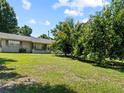 The house sits on a large, grassy lot filled with mature trees at 2800 Sunset Nw Dr, Winter Haven, FL 33881