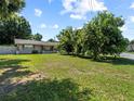 The house sits on a large, grassy lot with mature trees and landscaping at 2800 Sunset Nw Dr, Winter Haven, FL 33881